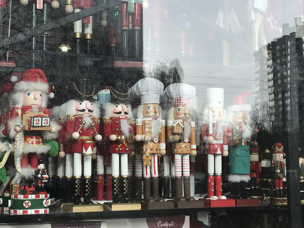 a bunch of nutcrackers that are in a window