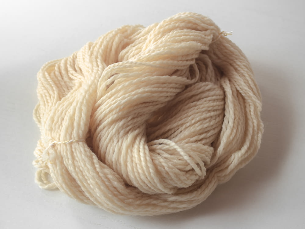 a skein of yarn on a white surface