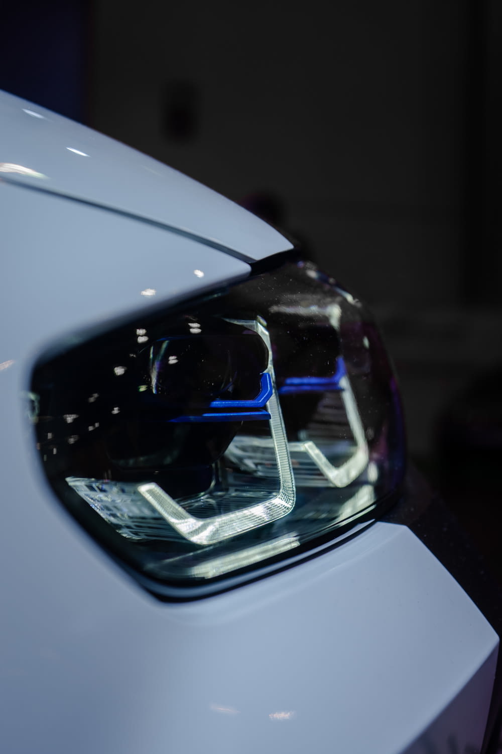 a close up of a white car's headlight