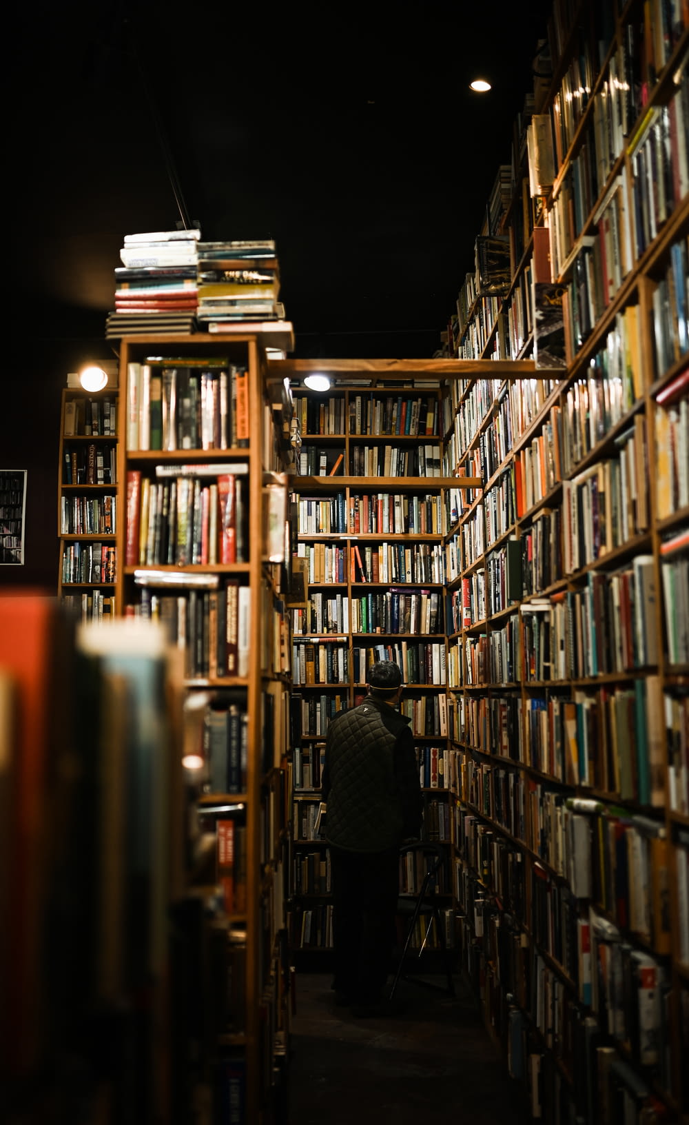 a person sitting in a room filled with lots of books