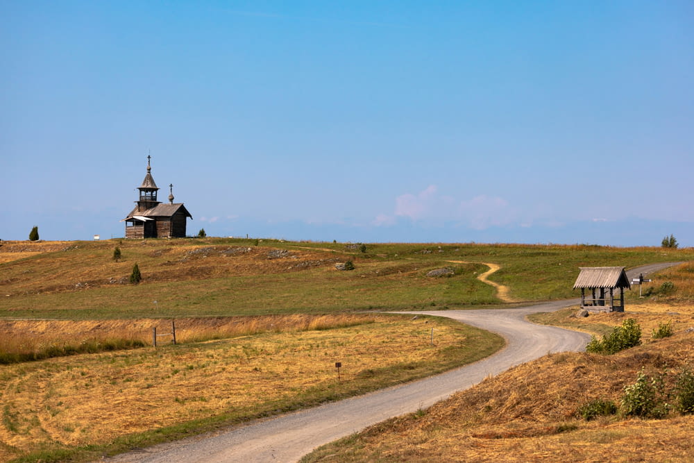 a rural road with a church on top of a hill