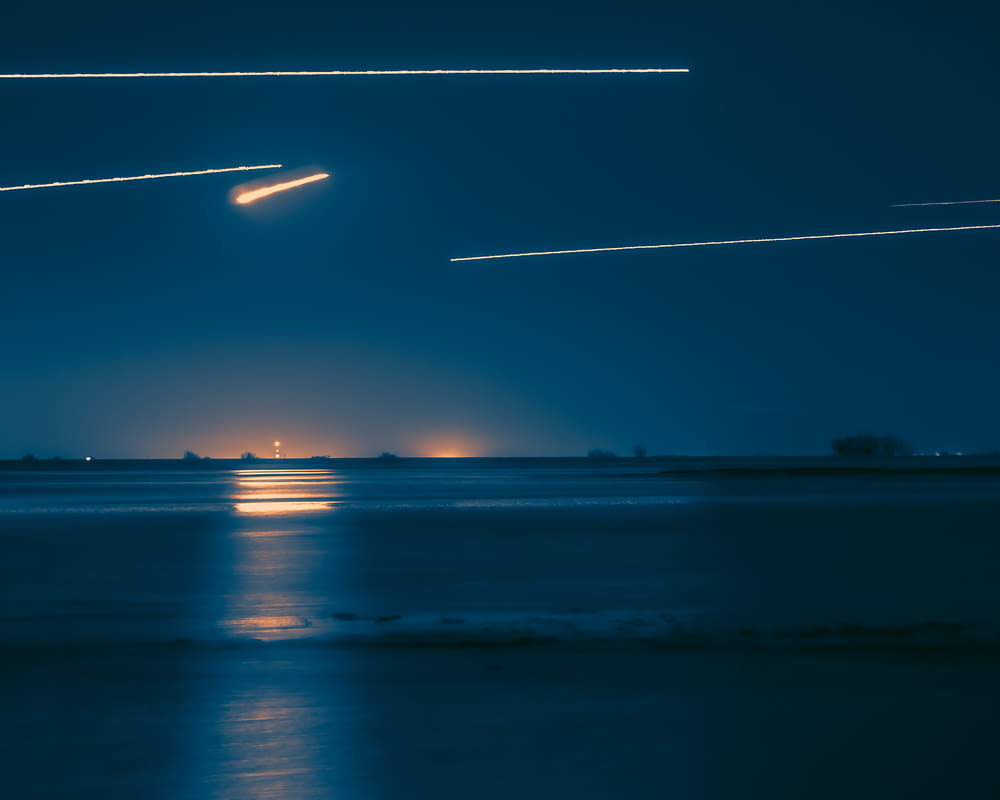 a group of airplanes flying over a body of water