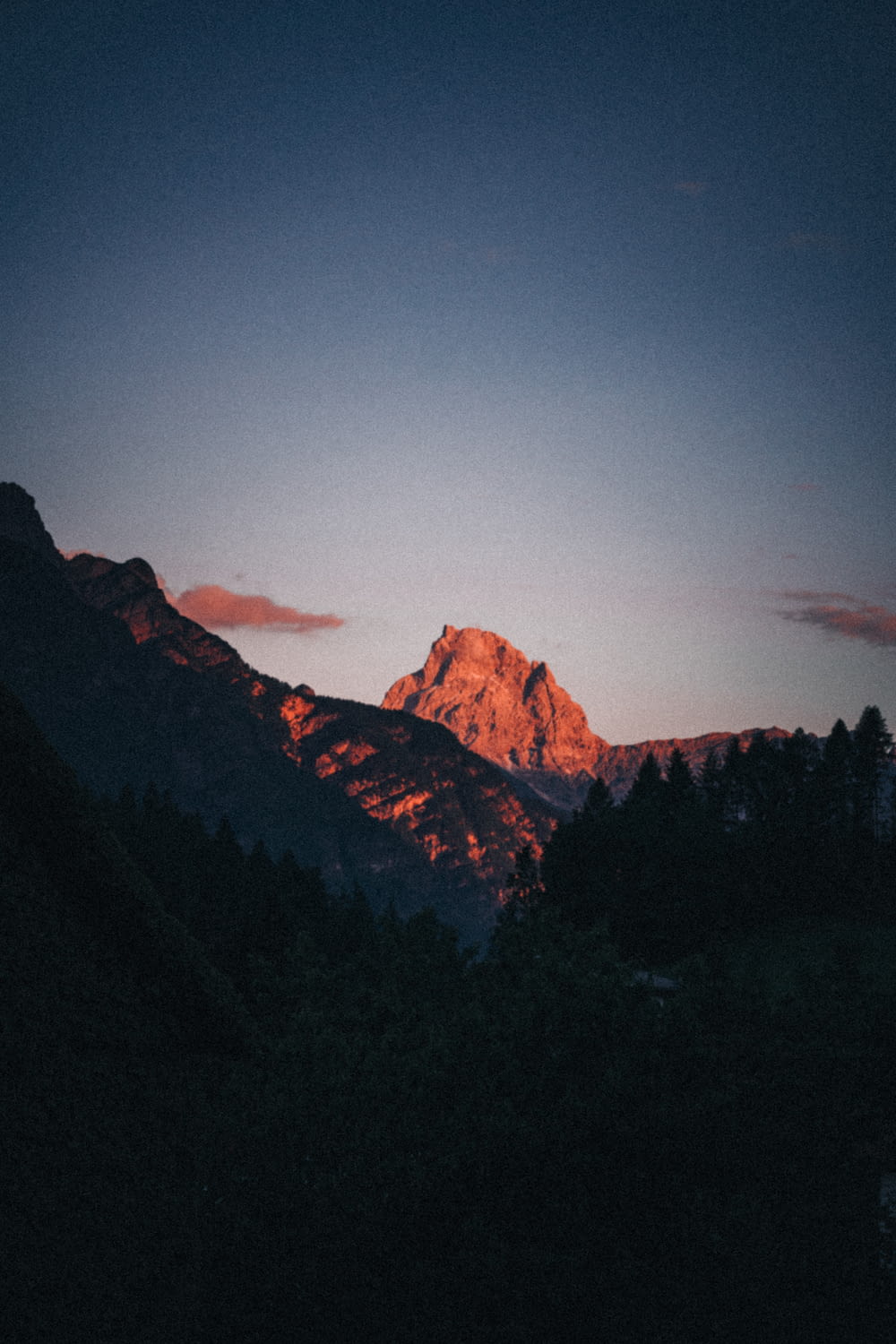 a mountain with a sunset in the background