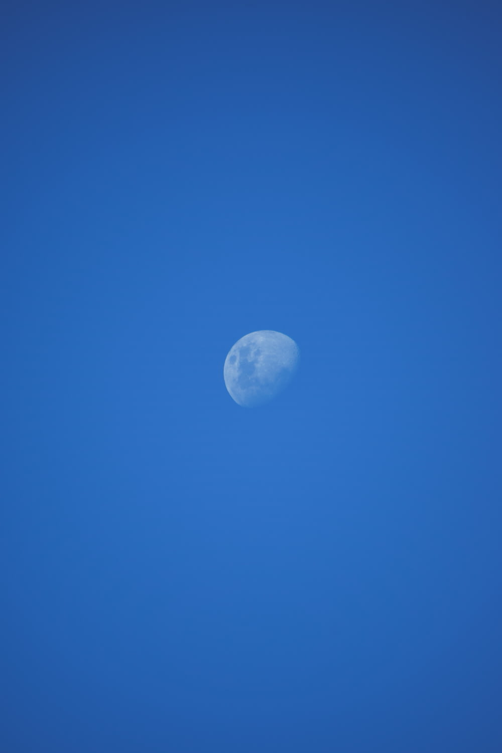 a plane flying in the sky with the moon in the background