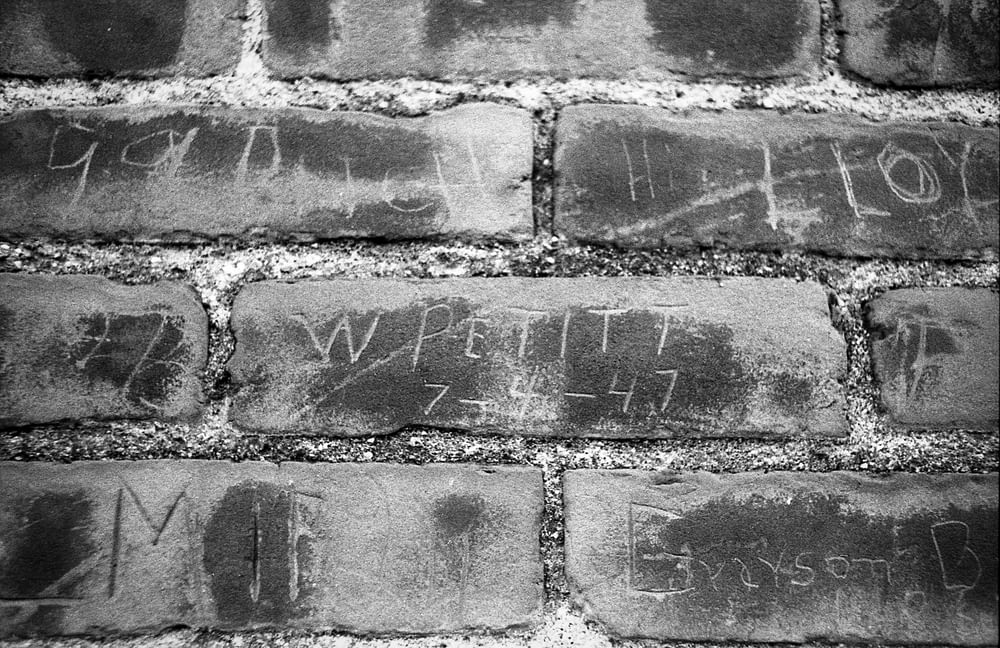 a brick wall with writing on it
