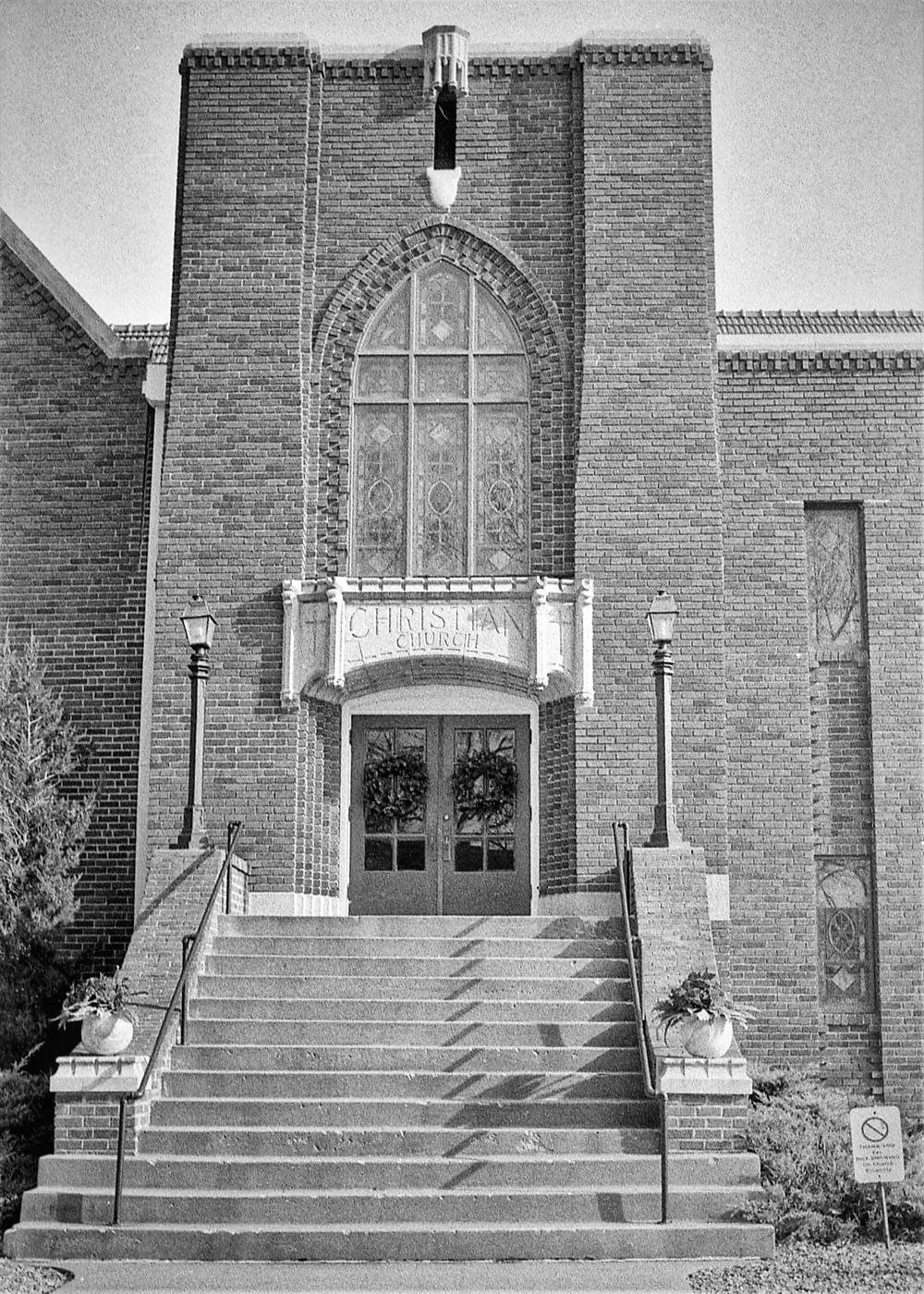 a black and white photo of a church entrance