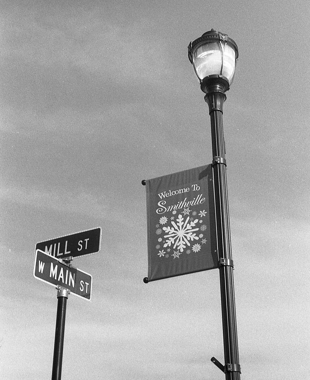 a street sign and a street light on a pole