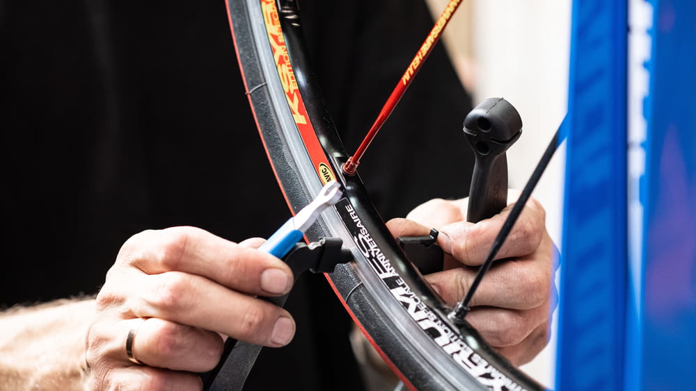 a close up of a person fixing a bike tire