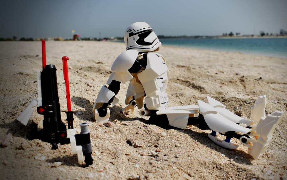 a star wars action figure on a beach