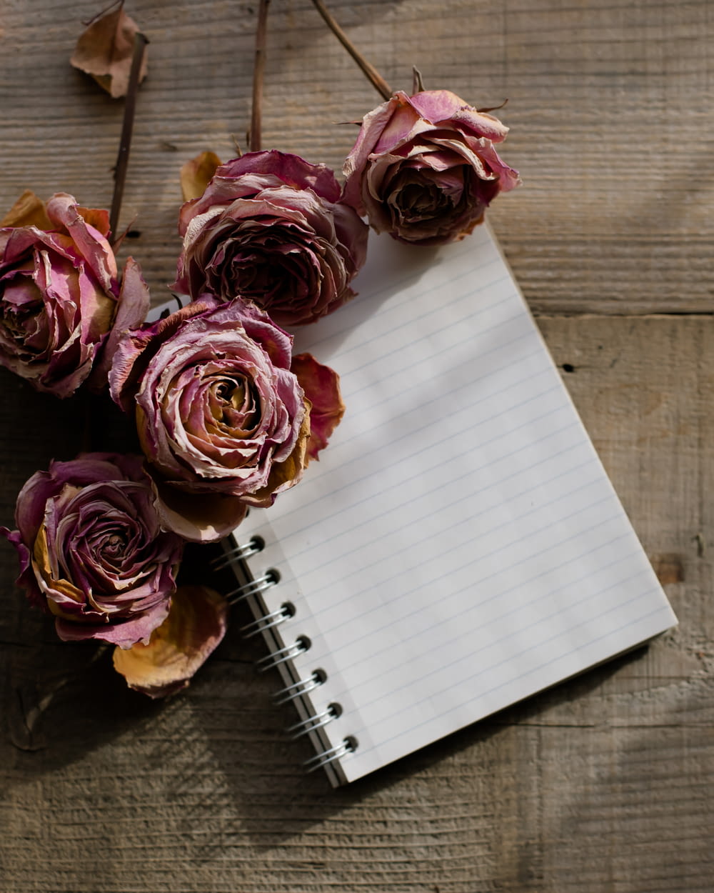 a notebook with a bunch of flowers on top of it