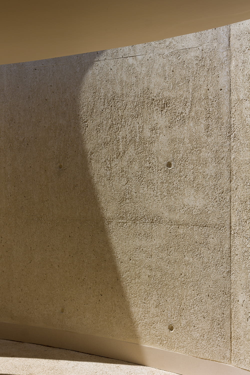 the shadow of a person sitting on a bench