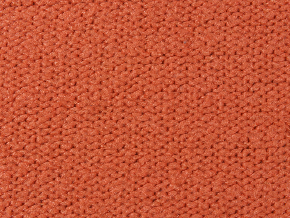 a close up of an orange carpet texture