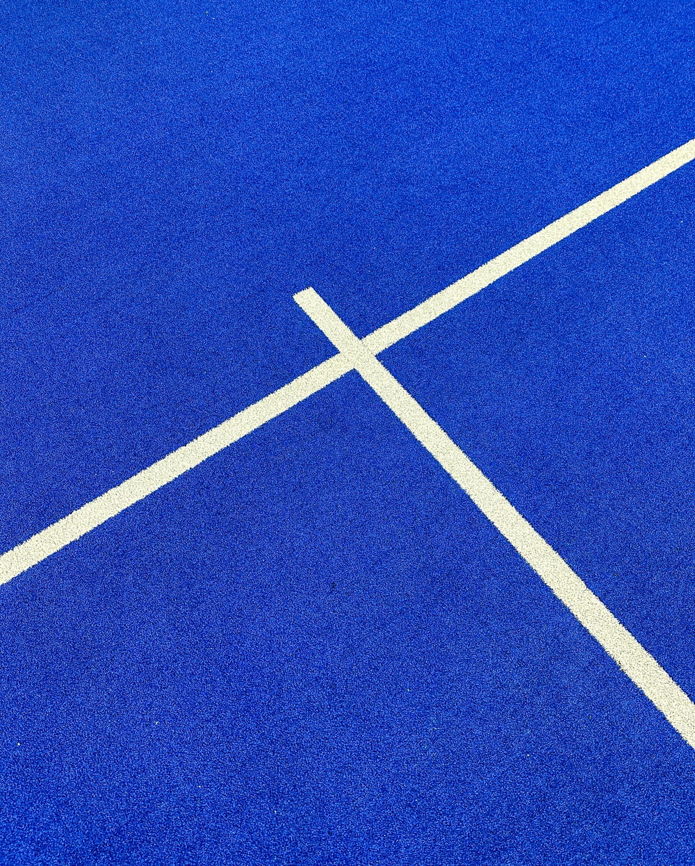 a blue tennis court with white lines on it