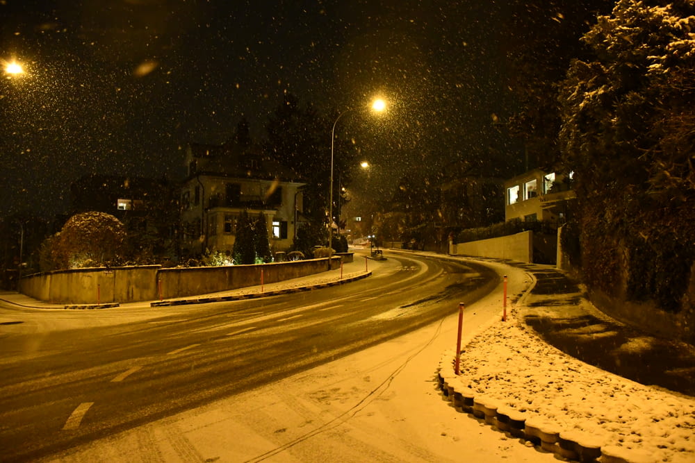 a snowy street at night with street lights