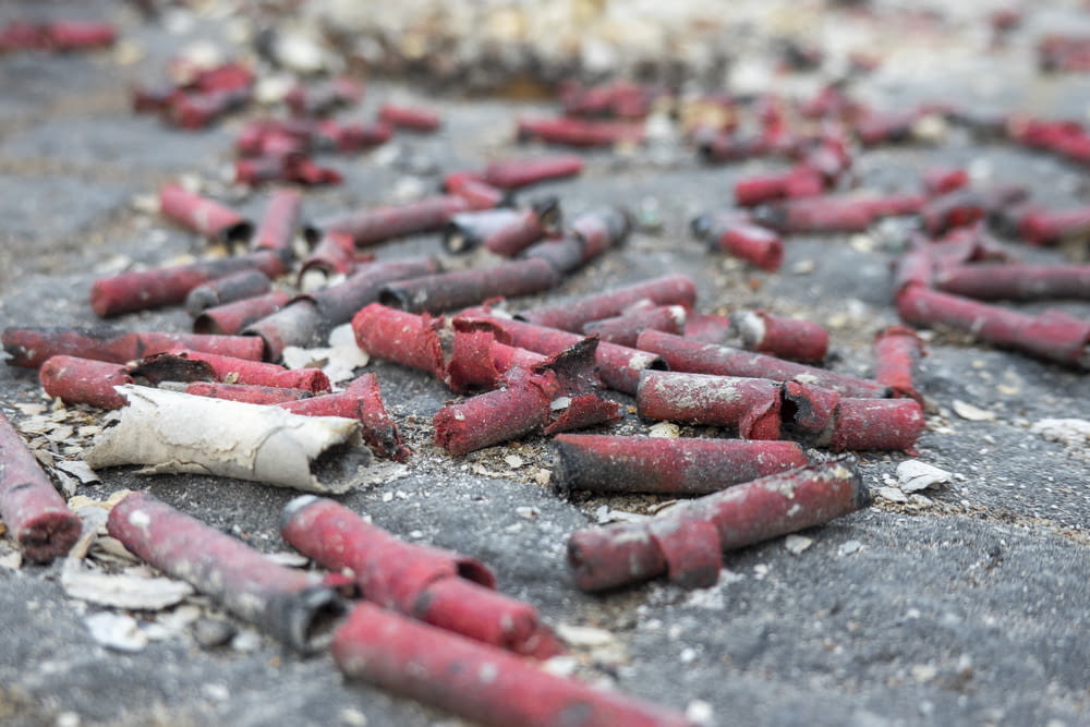 a bunch of red crayons that are on the ground