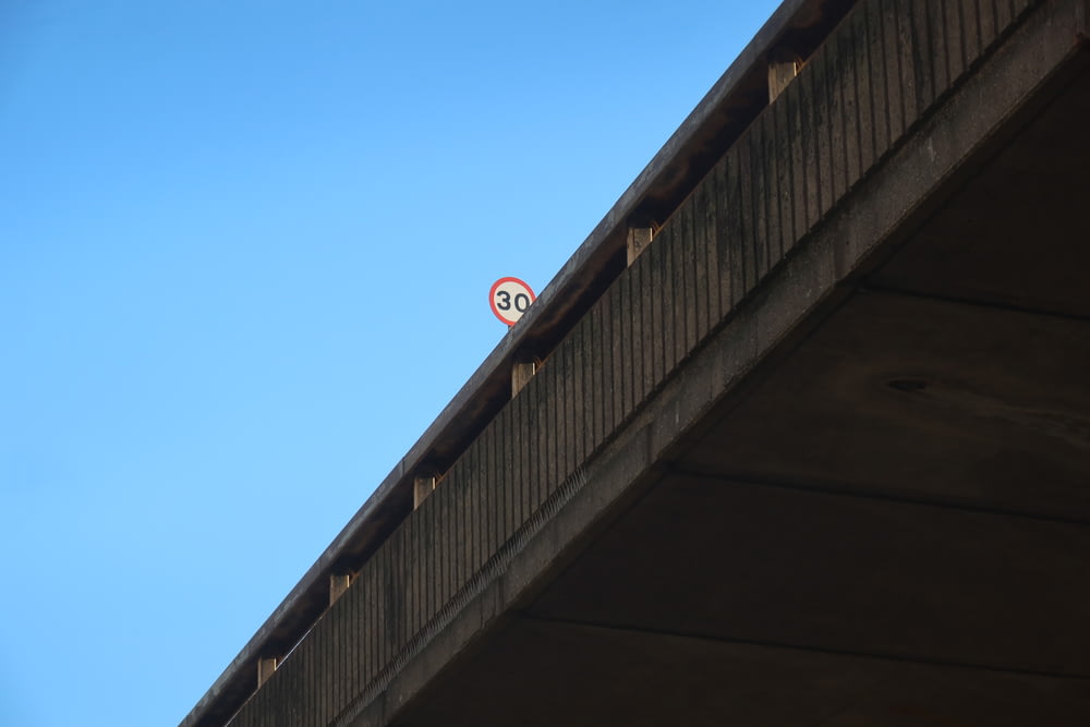 a no parking sign on top of a bridge