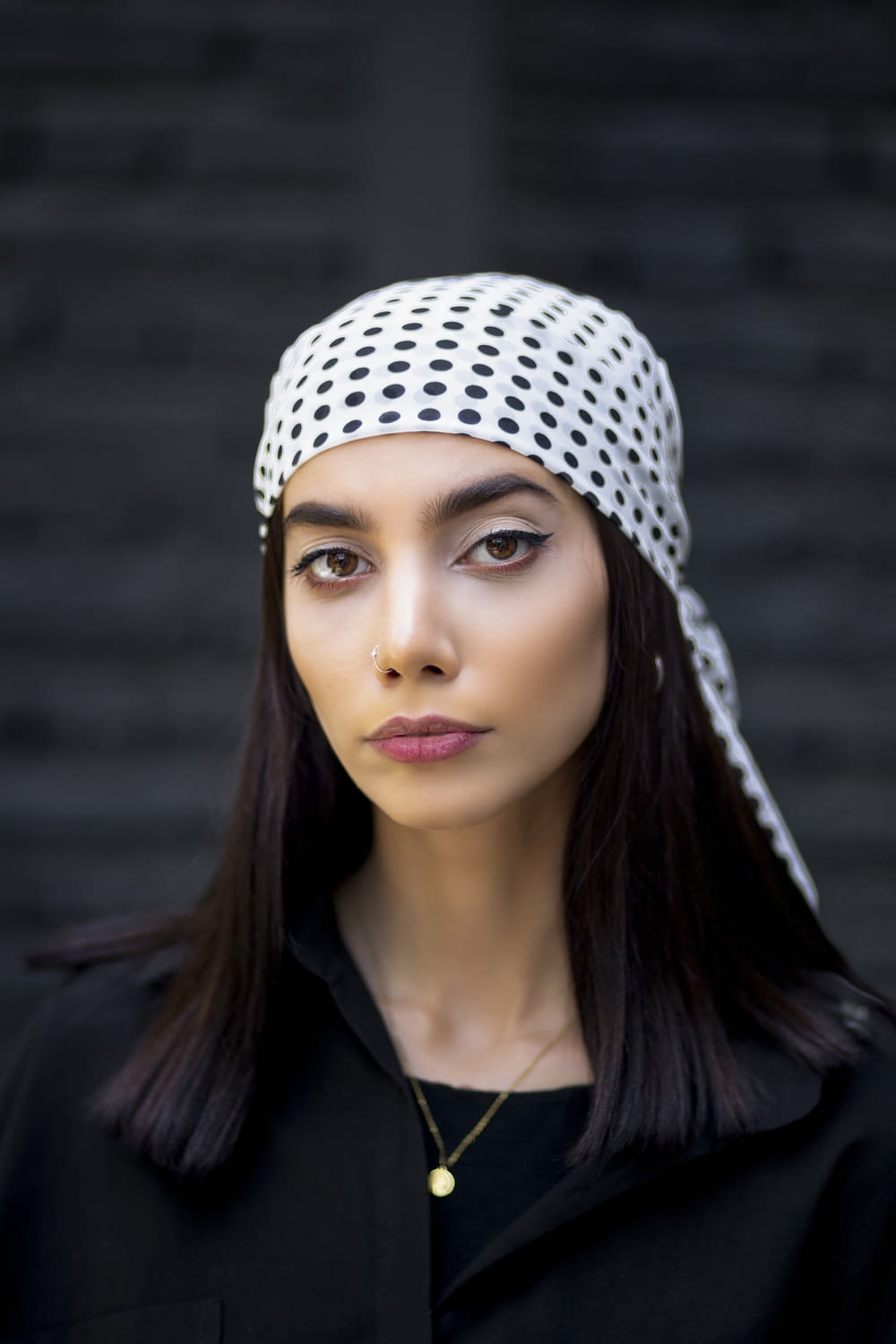a woman with long hair wearing a head scarf