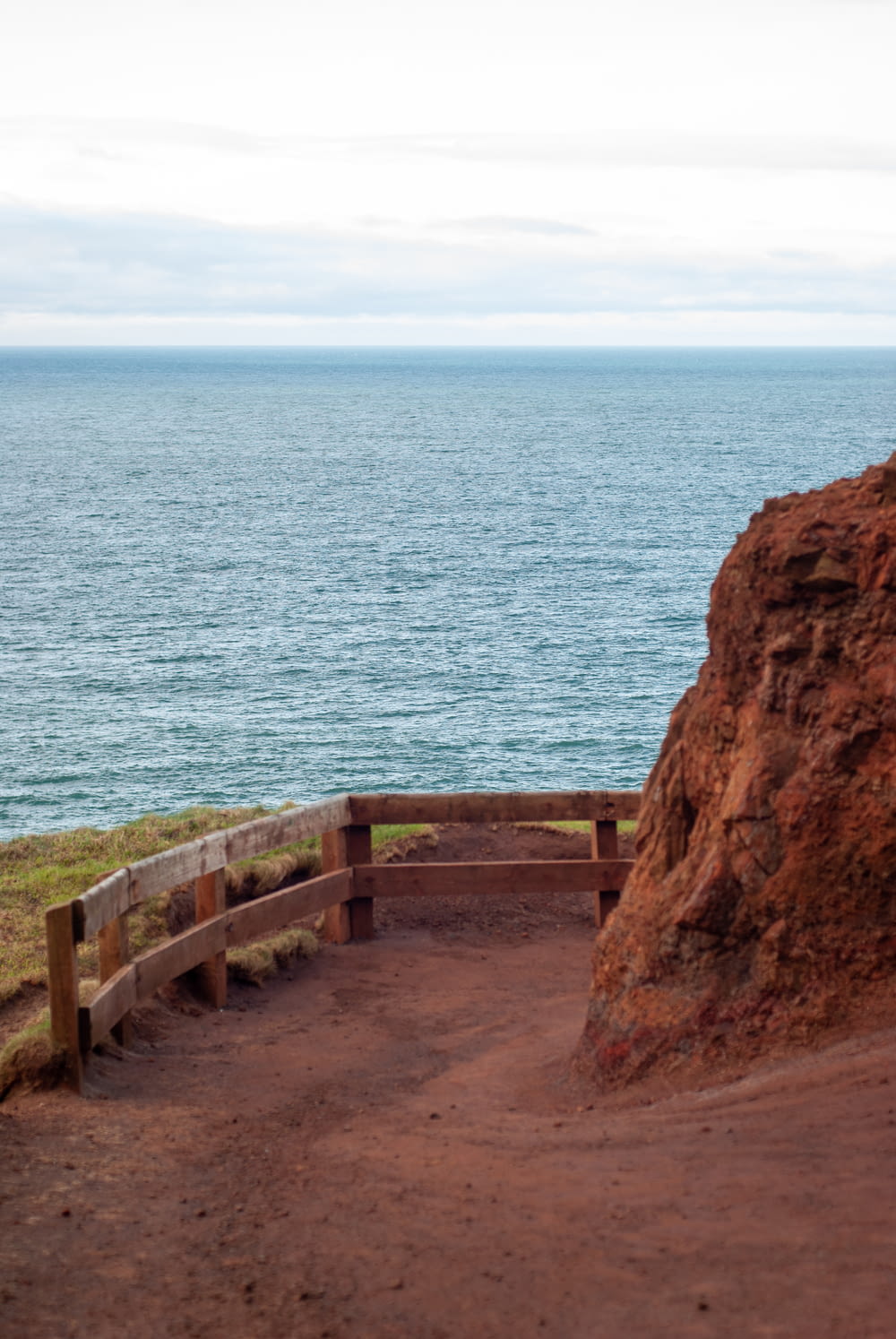 a bench on a cliff overlooking the ocean