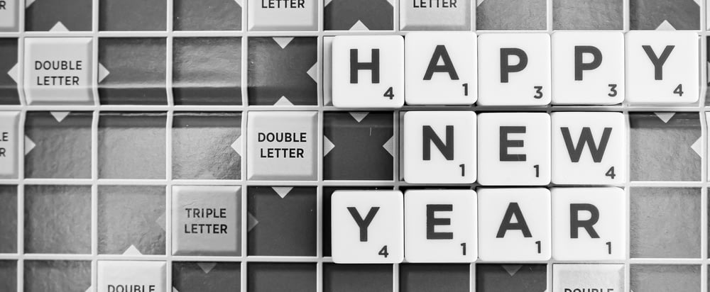 a happy new year spelled with scrabble tiles