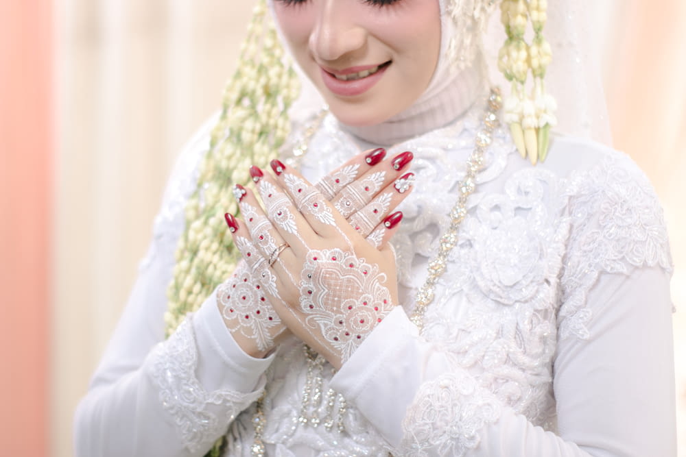 a woman wearing a veil and holding her hands together