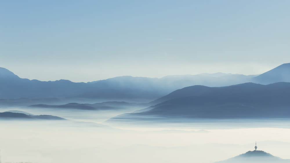 a view of a foggy mountain range in the distance
