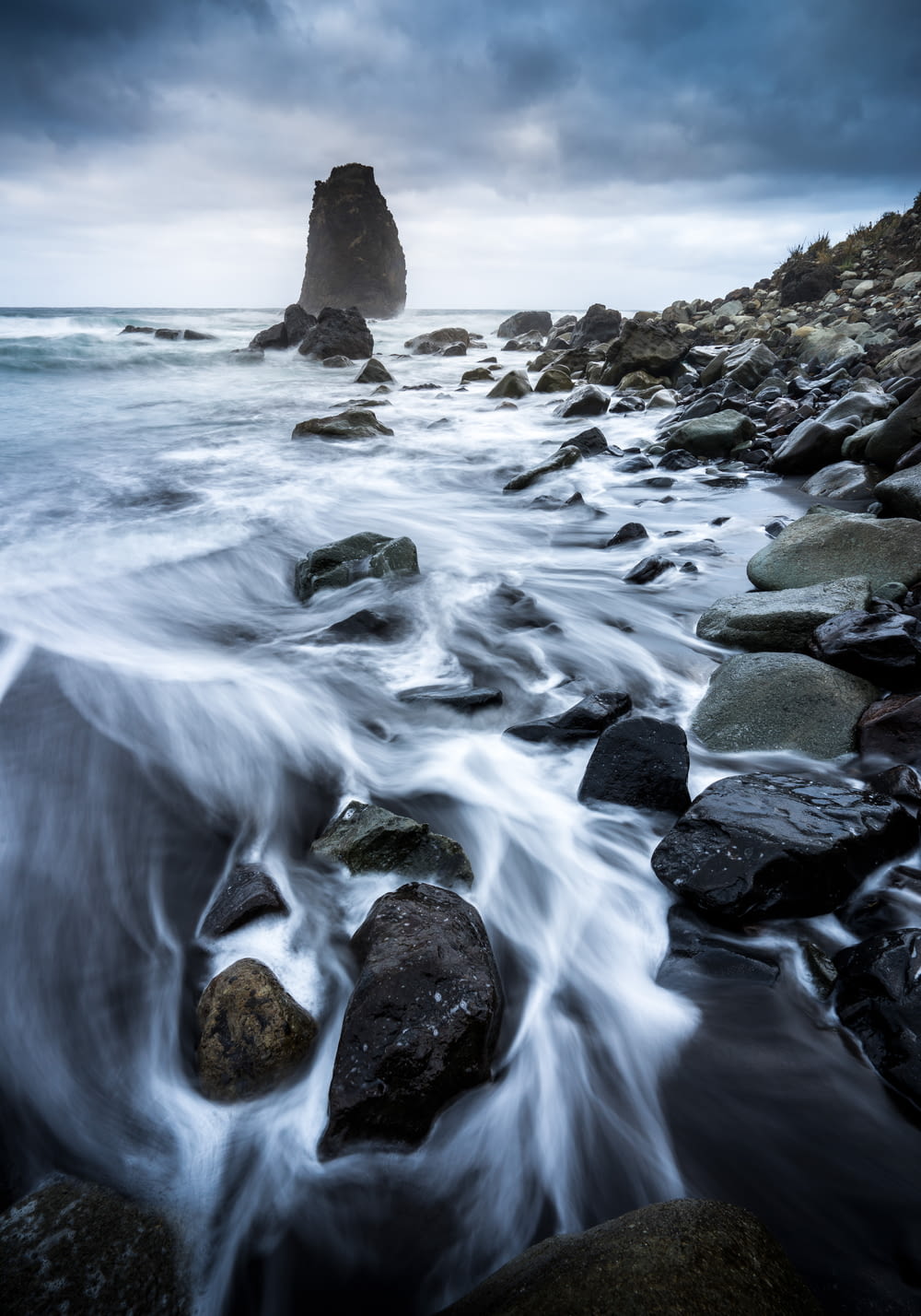 a long exposure photo of a rocky beach