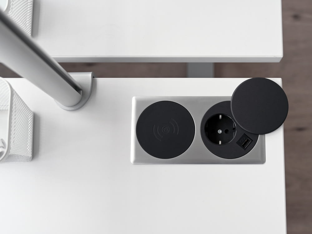 a white table with two black speakers on it