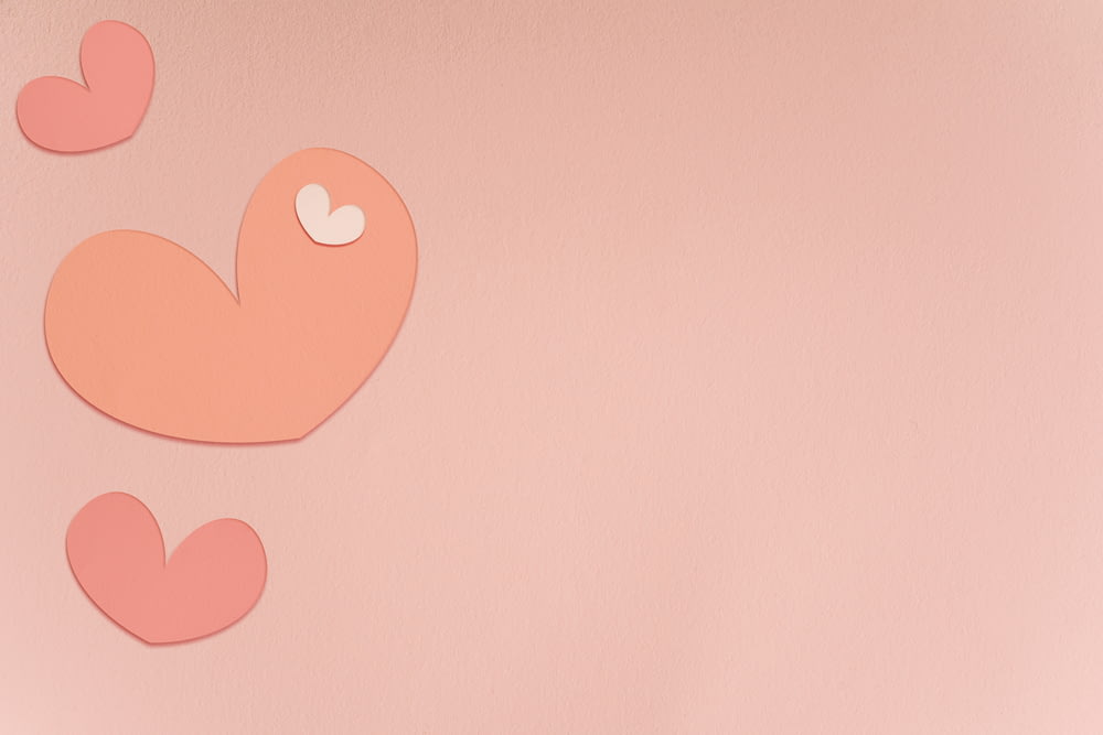 a pink wall with two hearts cut out of it