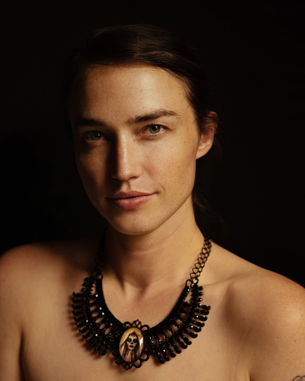 a woman with a necklace on her neck