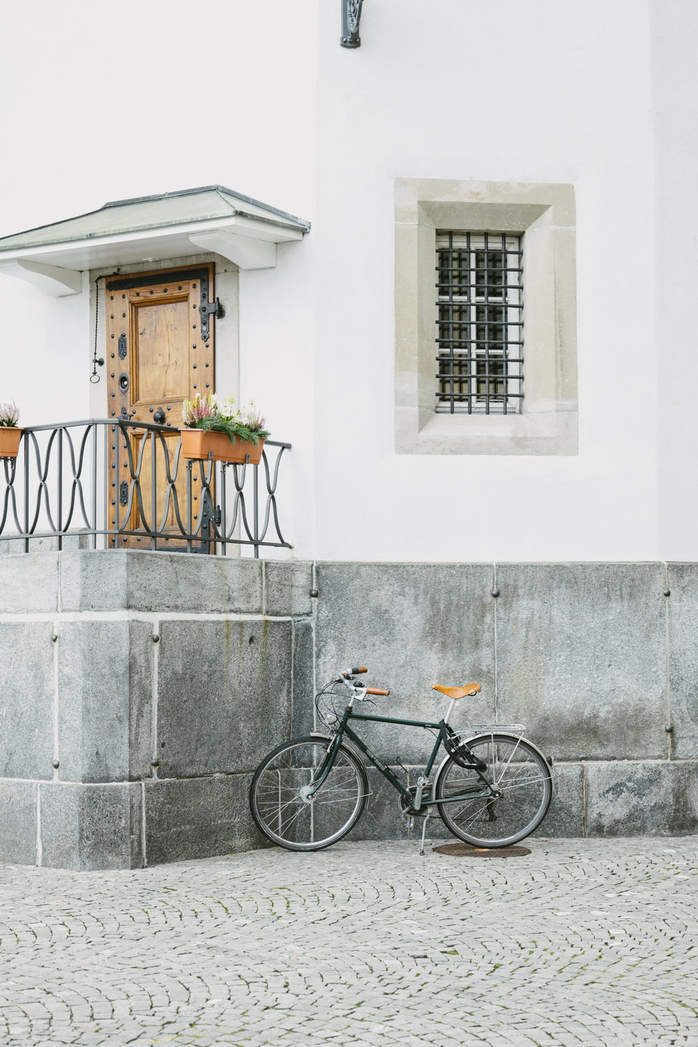 a bicycle parked in front of a white building
