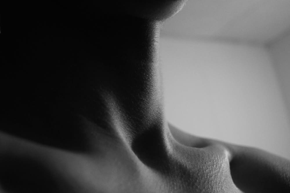a black and white photo of a woman's neck
