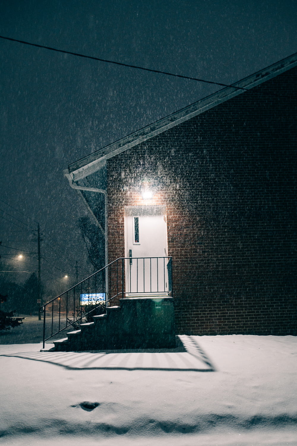 a building with a door and steps covered in snow