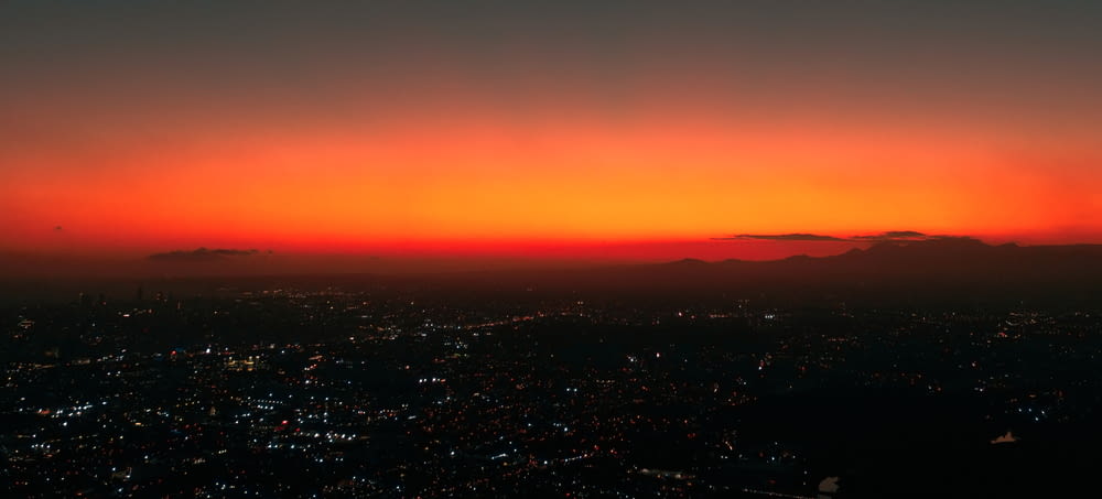 a view of a city at sunset from an airplane