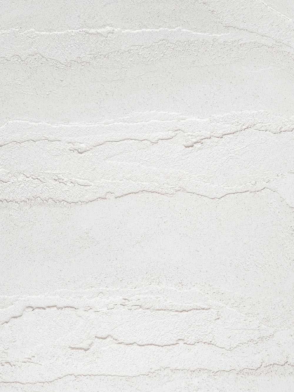 a white textured wall with a white background