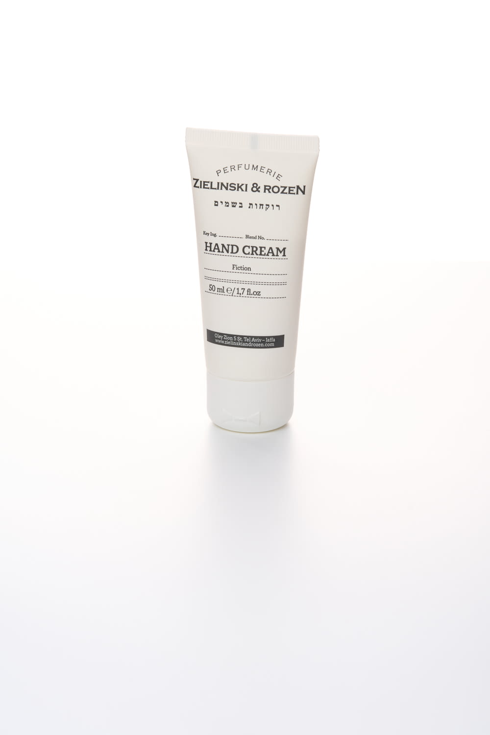 a tube of hand cream on a white surface