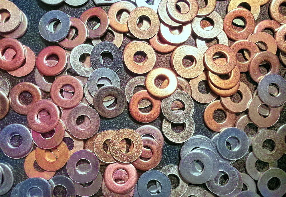 a pile of different colored washers sitting on top of a table