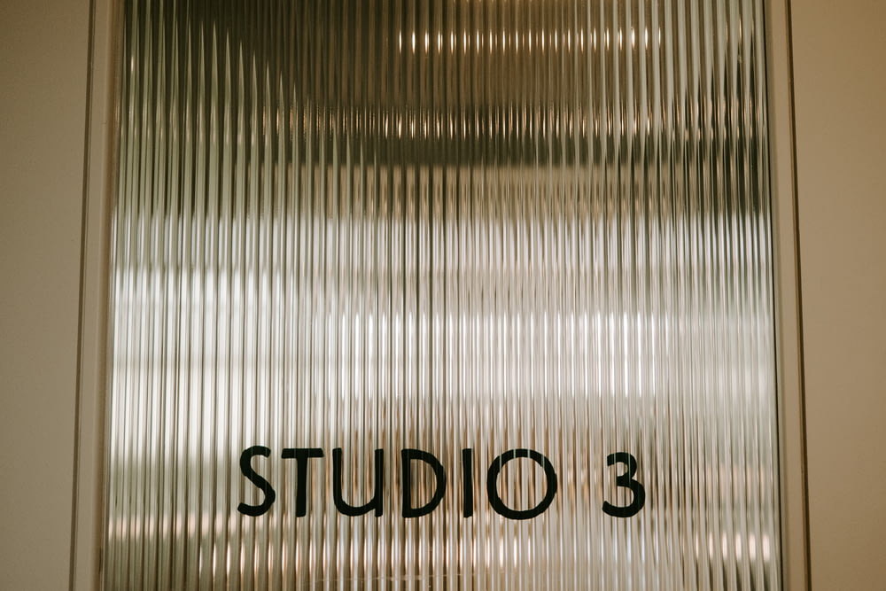 a close up of a door with the word studio 3 written on it