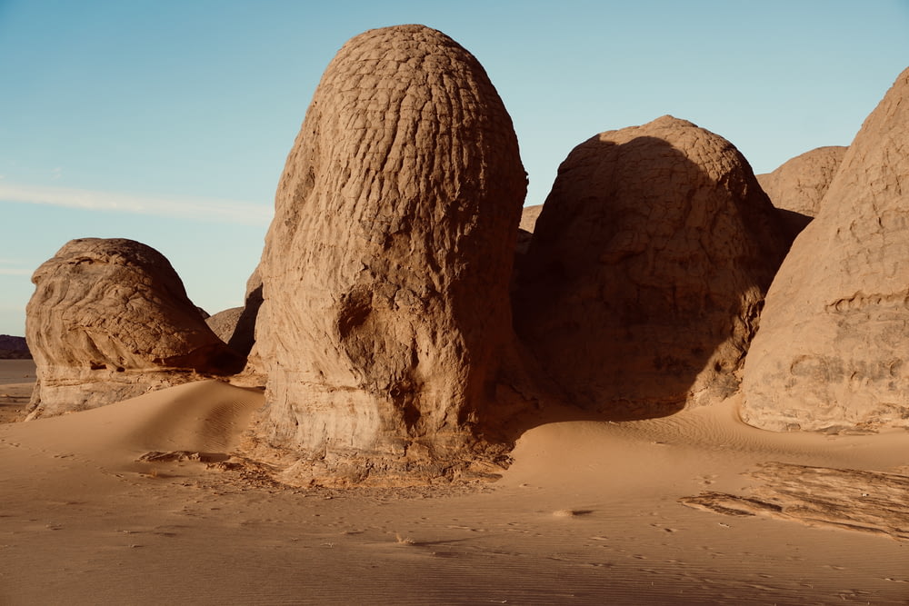 a group of large rocks sitting in the middle of a desert