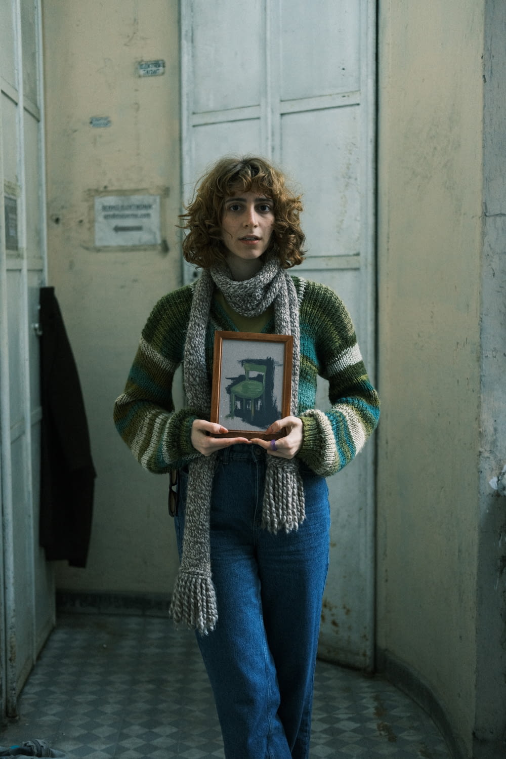 a woman holding a framed picture in her hands