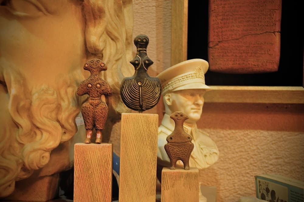 a group of figurines sitting on top of wooden blocks