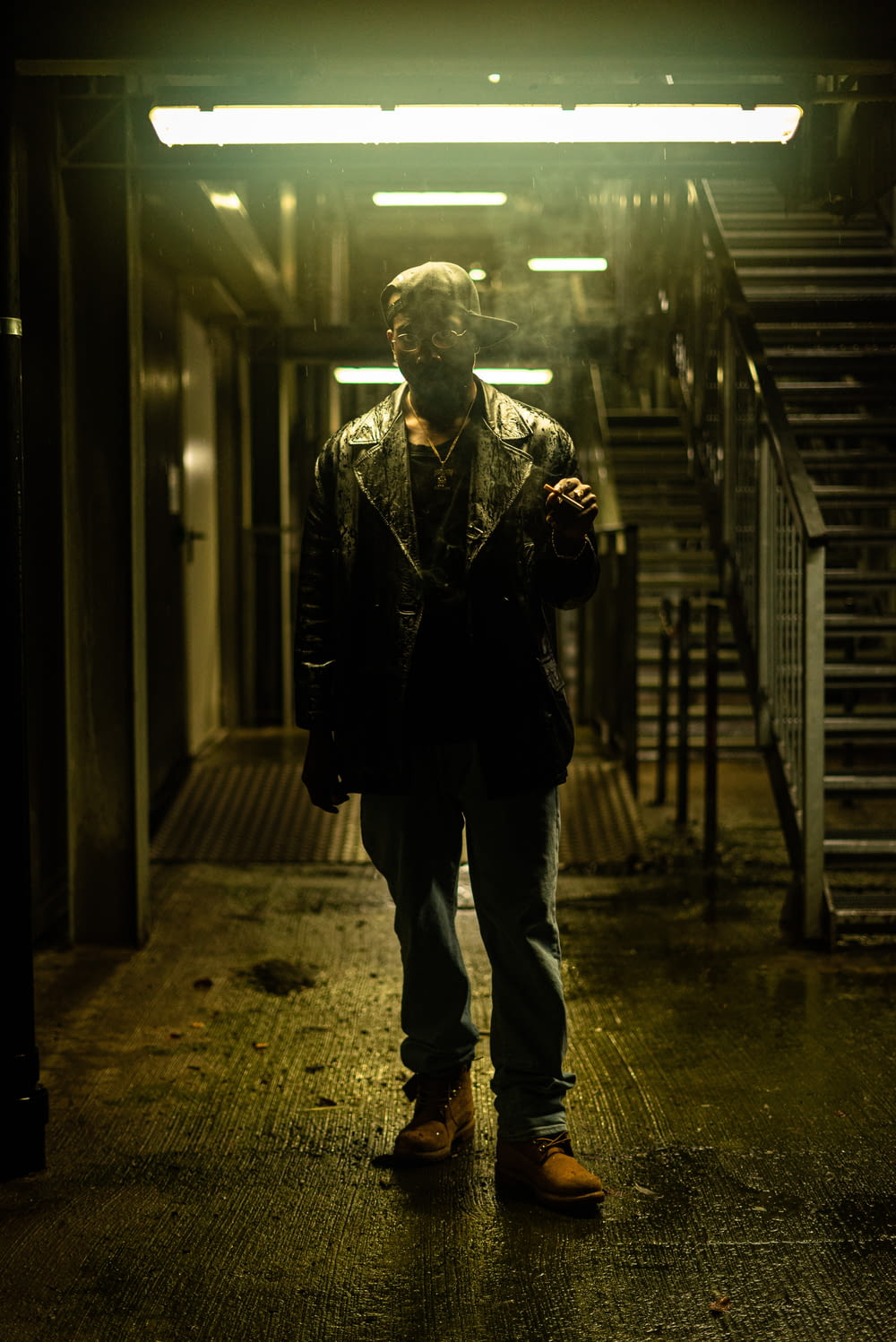 a man is standing in a dark hallway