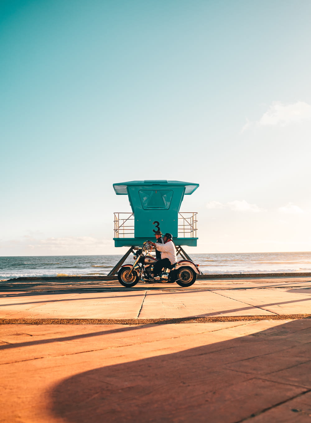 a motorcycle parked in front of a life guard tower