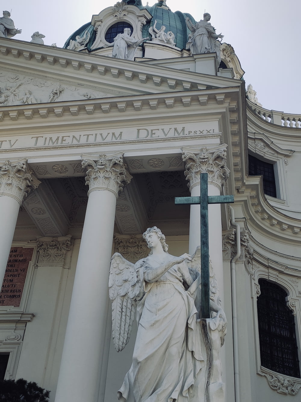 建物の前で十字架を掲げる女性の像