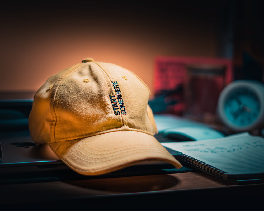 a yellow hat sitting on top of a desk