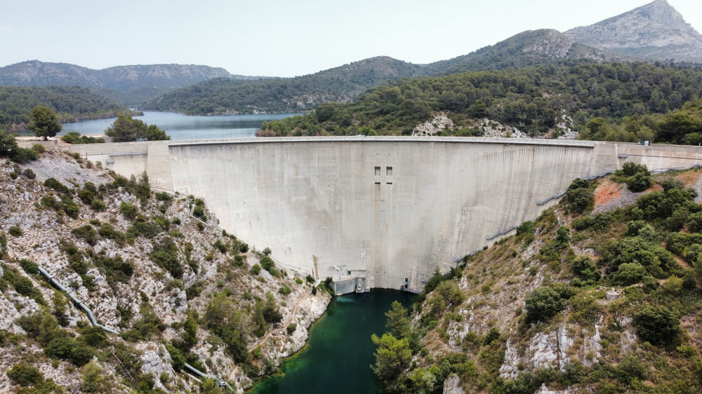 a large dam with a lake in the middle of it