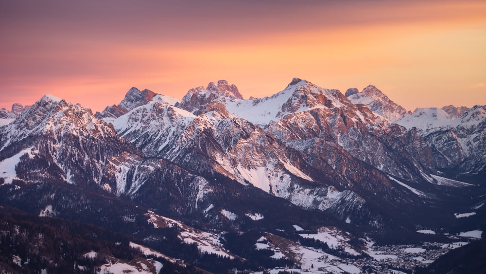 a mountain range with snow covered mountains in the background
