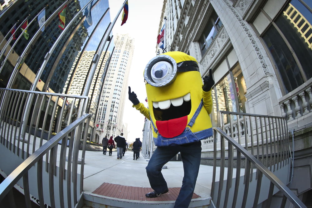 a man dressed as a minion walking down a flight of stairs