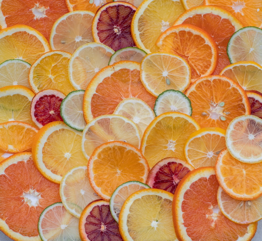 a bunch of oranges and lemons cut in half