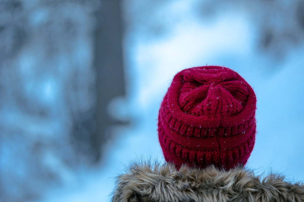 a person wearing a red hat in the snow
