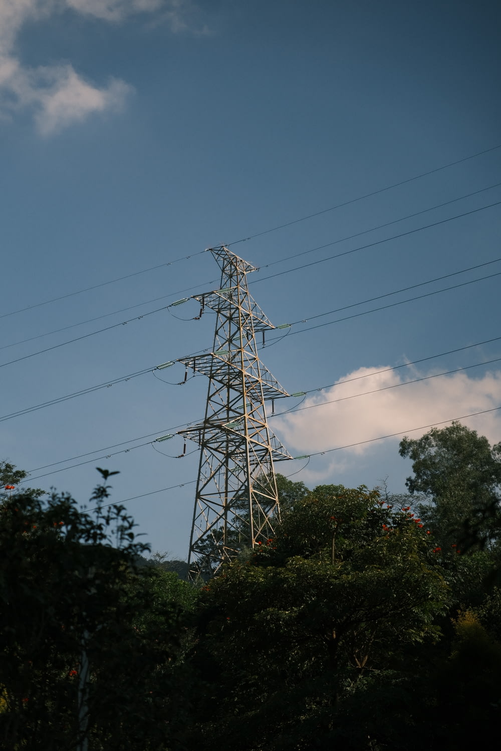 a tall tower with many power lines above it